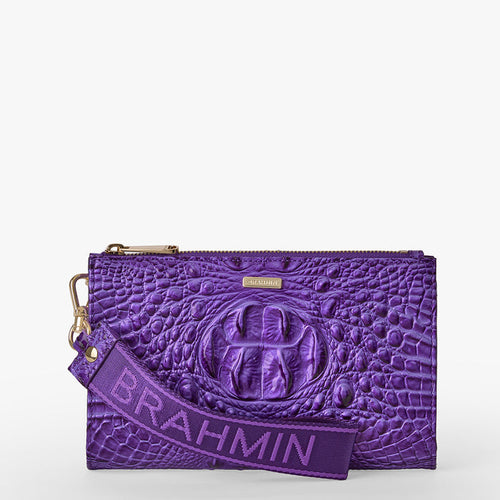 BRAHMIN Adia purple wristlet pouch with embossed textured pattern, gold zipper hardware, detachable strap, and bold BRAHMIN branding. Compact silhouette shown from the front.