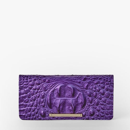 The Ady Wallet, a purple crocodile-patterned clutch expertly crafted from genuine cowhide leather and adorned with a metallic nameplate on the front, combines elegance and practicality with its thoughtfully designed credit card slots—all beautifully set against a plain white background.