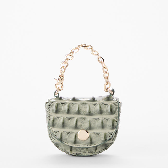A small green crocodile leather coin purse with a gold-tone chain handle and snap button closure, shown on a clean white background.