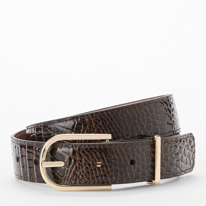 The Medium Gold Buckle Belt is crafted from chocolate brown, croc-embossed leather with a shiny finish and features a gold buckle. The belt is coiled in a loop against a plain white background.