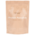 True Protein Protein Pancakes French Vanilla 300g resealable pouch, pale peach packaging with pancake icons — gluten free, no added sugar, 24.5g protein per serve, made in Australia.