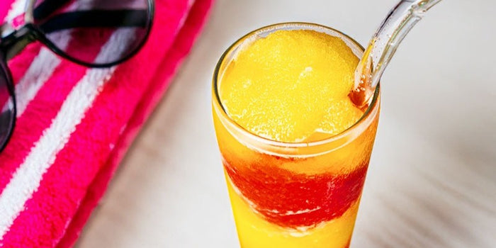 Swirling layers of berry Pelican Red Rush Sweetzer with zesty lemonade in a frosty wine slushie. Easy recipe!