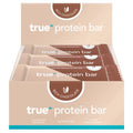 True Protein Bar rich chocolate 12-pack display box, beige and brown packaging, 12 x 63g bars (63g serving), 17.2g protein per serving, retail box for online sale.